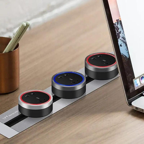 Sleek Concealed Power Track Socket Offering Four Dedicated Plug Outlets For Lowkey Kitchen Counter Organization And Modern Home Electrical Flexing Heavy Duty Sandblasted Aluminum Finish with three outlets on wood desk.