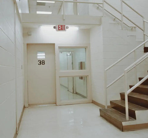 2 In 1 LED Exit Sign And Emergency Light Combo With Red Letters High Output Battery Backup above door in hallway