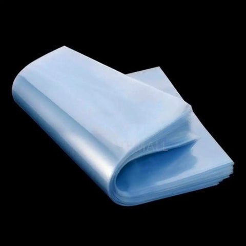 Hassle Free 100 Pack Clear Pvc Heat Shrink Bags 7X10 Inches stacked showing smooth, transparent pouches for gift wrapping and packaging.