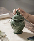 Top Tier Ceramic Airtight Tea Canisters For Loose Tea Leaves And Coffee Beans Hand Embossed Celadon Kirin Design on kitchen counter