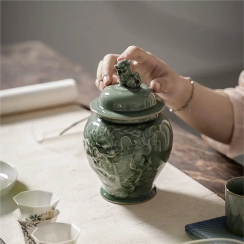 Top Tier Ceramic Airtight Tea Canisters For Loose Tea Leaves And Coffee Beans Hand Embossed Celadon Kirin Design on kitchen counter