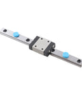 Side view: 100mm linear rail guide with sliding block on silver steel rail, blue caps, Amazon