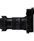Side view of 18-50mm F2.8 DC DN Contemporary Lens for Canon RF Mount Mirrorless, attached to camera, showcasing compact design.