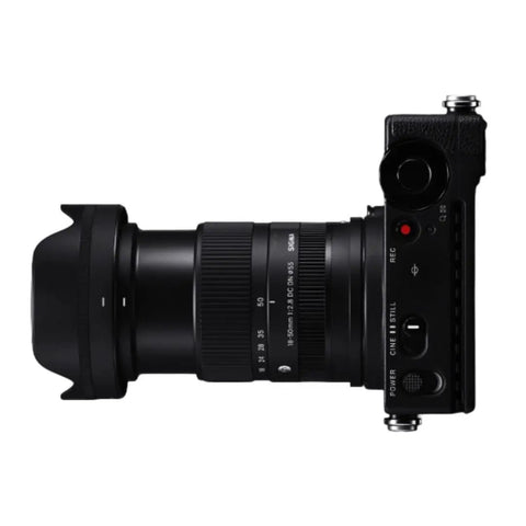 Side view of 18-50mm F2.8 DC DN Contemporary Lens for Canon RF Mount Mirrorless, attached to camera, showcasing compact design.