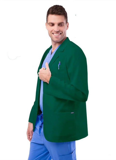 Pro Approved Unisex Lab Coat For Healthcare Crew Featuring Stacks Of Storage In Dual Patch Pockets And A Handy Chest Divider Classic Hunter Green Cut With A 31 Inch Back Hem Built Tough For Long Haul Clinic Days, modeled by man in scrubs with a thumbs up.