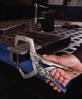 User holding Welding Pliers With Fast Release And C Clamp Locking 11 Inch High Temperature Work Ready on metal piece in workshop.