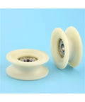 Heavy Duty U Groove V Groove Nylon Caster Wheel With Steel Bearing Built Tough Rolling Smooth For Sliding Gates Industrial Trolleys And Machinery Tracks showing two nylon wheels with steel bearings on a blue background.