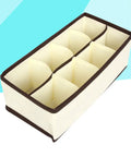 Top Tier Setup For Messy Drawers This Foldable Beige Drawer Organizer features eight compartments for socks and underwear.