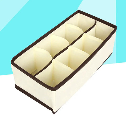 Top Tier Setup For Messy Drawers This Foldable Beige Drawer Organizer features eight compartments for socks and underwear.
