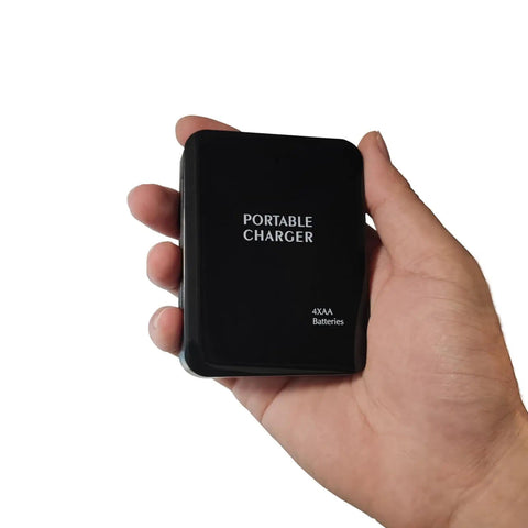Hand holding Battery Operated Phone Charger With LED Light And USB Output Emergency Power Bank Powered By 4 AA Batteries Portable 2 Pack Black