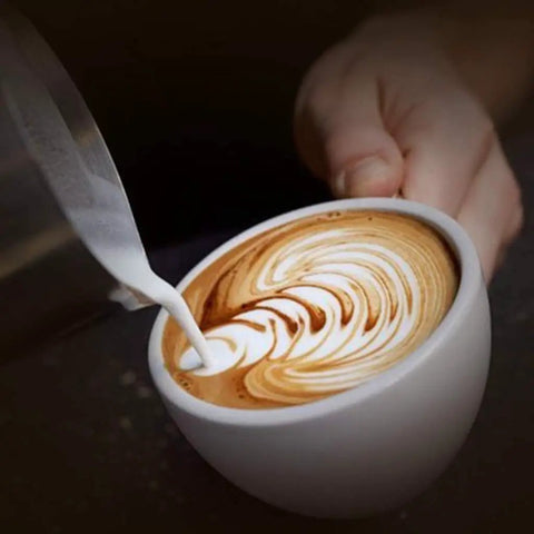 Top Shelf Semiautomatic Espresso Maker With A Mean 20 Bar Pump And Sleek Milk Frother pouring milk into latte art in white cup.