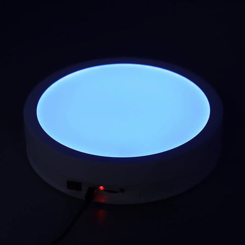 Depisuta 22cm Electric Rotating Turntable Display Stand With Led Colorful Light Remote Control displaying blue LED light.