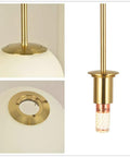 Lit Globe Pendant Light With Matte White Glass And Brass Finish, One Light Modern Hanging Fixture For Home, close-up details