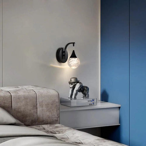 Crystal Bubble Wall Sconce With Dimmable LED 5W, 3300K Warm White, Matte Black Finish, on a bedroom wall above a nightstand