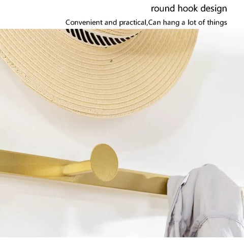 Heavy Duty Coat Rack And Shoe Storage Bench For Entryway Featuring Industrial Metal Frame Upholstered Seat With Sturdy Hooks And Plush Cushion Comfort Built Tough Enough To Handle The Daily Grind showing round golden hook design holding a hat and clothing.