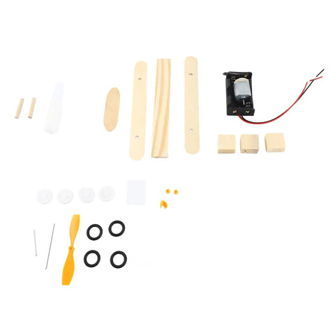 Parts laid out for Electric Wood Glider Aircraft Model Kit For Kids 7 And Up with wood, plastic, and metal components.
