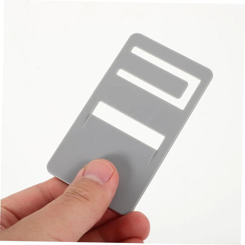 Gray durable clips from the Rv Refrigerator Handle Repair Kit 2 Pack Durable Door Prop Clips For Seamless Fixes Quick And Easy Installation Repair Damaged Handles And Rv Door Parts DIY Friendly And Budget Saver held in hand.
