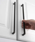 Person holding Oil Rubbed Bronze Solid Square Bar Cabinet Pull Handles Set Of 5 10 Inch 256mm Screw Hole on white cabinet