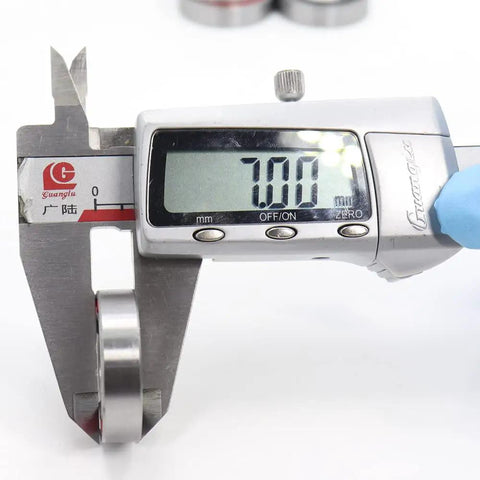 Measuring 18x28x7 Millimeter Double Sealed Ball Bearing 2RS thickness with digital caliper for bicycle hub front and rear wheels.