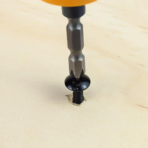 Pro Grade No 6 By One Half Inch Truss Head Wood Screws, 100 Count, 304 Stainless Steel, Black Oxide Coated, Self Tapping Phillips Drive Screws For Wood And Sheet Metal, Includes Phillips Driver Bit being installed into wood.