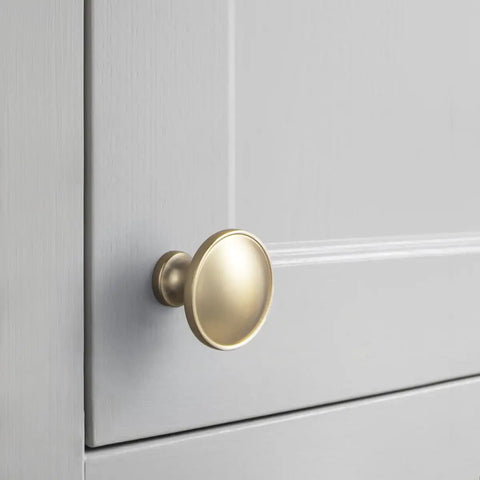 Close-up of 12 Pack Champagne Bronze Cabinet Knobs 1.25 Inch Round Heavy Duty Zinc Alloy Hardware on gray cabinet