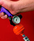 Heavy Duty Mini Air Regulator Gauge With Locking Adjustment Knob And Crystal Dial in use with hand gripping gauge, showing pressure.