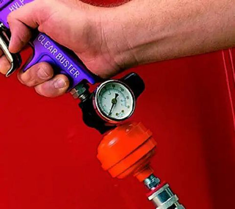 Heavy Duty Mini Air Regulator Gauge With Locking Adjustment Knob And Crystal Dial in use with hand gripping gauge, showing pressure.