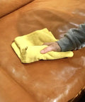 Person applying Leather Conditioner With Deep Nourishing Moisturizers And Natural Waxes To Restore Dried Leather To A Soft Natural Feel