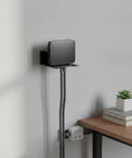 Wall Mounted Floating Shelf Bracket In Carbon Steel For Sturdy Open-Frame Support, showcasing a small gadget elevated over a desk