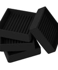 High Performance Non Slip Furniture Cups And Square Caster Pads For Hardwood Floors stacked black rubber pads with ribbed texture.