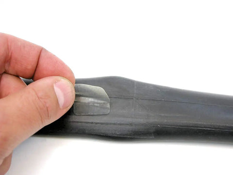 Applying pre-glued tube patch from the On The Go Cyclist Essential Tool Kit With Tire Levers, Fold Up Hex And Screwdriver