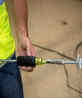 Person using Go-To Heavy-Duty Nut Driver With Hollow Shaft For Long Bolts, Nine Sixteenth Inch Tip, and Cushion-Grip Handle.