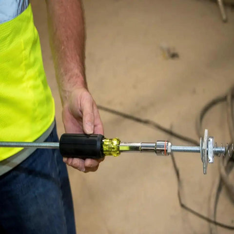 Person using Go-To Heavy-Duty Nut Driver With Hollow Shaft For Long Bolts, Nine Sixteenth Inch Tip, and Cushion-Grip Handle.
