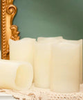 Flickering Flameless LED Candles Real Wax Pillar Set Of 6 on a lace table, battery operated pillars 5 inches tall by 3 inches wide