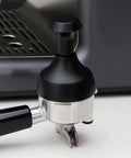 Upgrade Your Daily Brew Routine With This Dope Adjustable Espresso Coffee Tamper And Premium Needle Distributor Leveler Compatible With Most 58Mm Portafilters showing black tamper on silver portafilter.