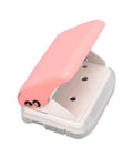 Three Hole Punch Handheld Paper Puncher With Five Sheet Capacity And Alignment Posts in pink, showing three punch holes, portable design.