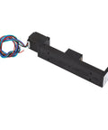 Side view of black linear slide stage actuator with NEMA 11 stepper motor, multi-color wires, and 100 mm travel.