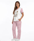 Woman modeling Stethoscope Teeth Print Scrubs Set for Women Pink Pants 2 Piece Nursing Uniform Featuring V Neck Top and Straight Leg Pants