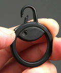 Close-up of a black detachable metal zipper pull replacement held in hand, used for suitcases, luggage, backpacks, and jackets.