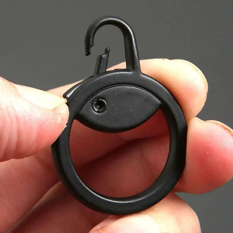Close-up of a black detachable metal zipper pull replacement held in hand, used for suitcases, luggage, backpacks, and jackets.