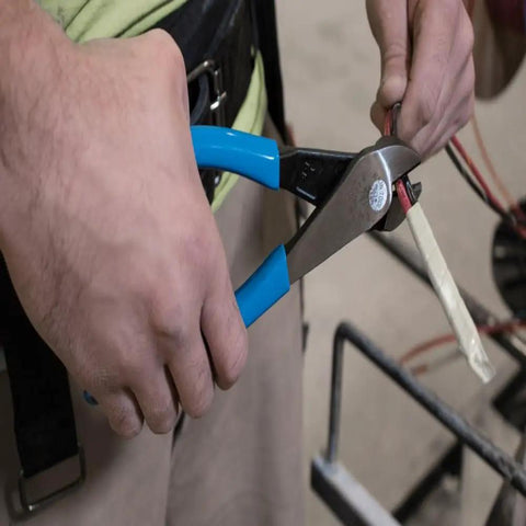 Close-up of hands using Beefy Heavy Duty Diagonal Cutting Pliers With Angled Head For Tight Cuts On ACSR Screws Nails And Hardened Wire, 8 Inch.