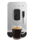 Fully Automatic Coffee Machine With Steam For Home Use Black BCC12BLMUS Six Drink Options Including Ristretto And Espresso Built In Stainless Steel Burr Grinder Titan Renew Water Tank Easy To Use showing front view with glass cup of coffee