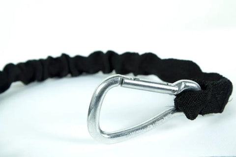 Close-up of metal carabiner on shock absorbing bungee tug line for skijoring and bikejoring, hands free dog leash with waist belt compatibility