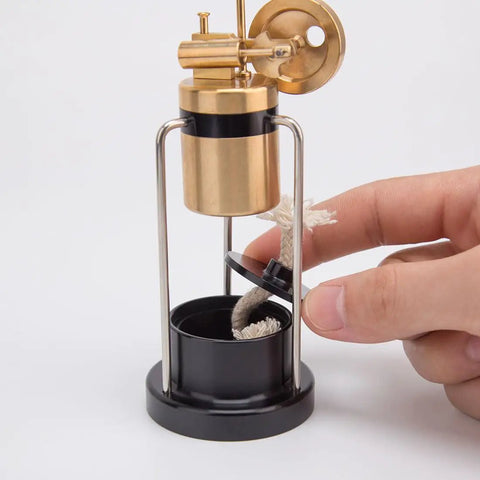Retro Three Legged Oscillating Steam Engine Model Kit showing brass boiler with hand adjusting wick in base