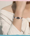 Woman wearing a bracelet with a 3D cat face bead from Colorful Acrylic Cat Beads Kit 100 Pcs, Cute 3D Cat Face Spacers For Jewelry Making.