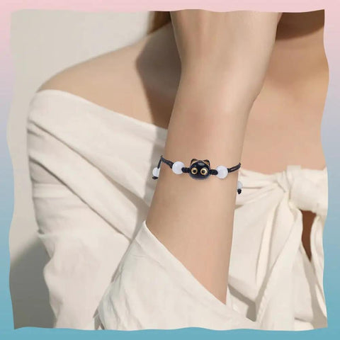 Woman wearing a bracelet with a 3D cat face bead from Colorful Acrylic Cat Beads Kit 100 Pcs, Cute 3D Cat Face Spacers For Jewelry Making.