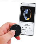 Wireless Bluetooth Car Media Button With Steering Wheel Remote next to smartphone displaying music app