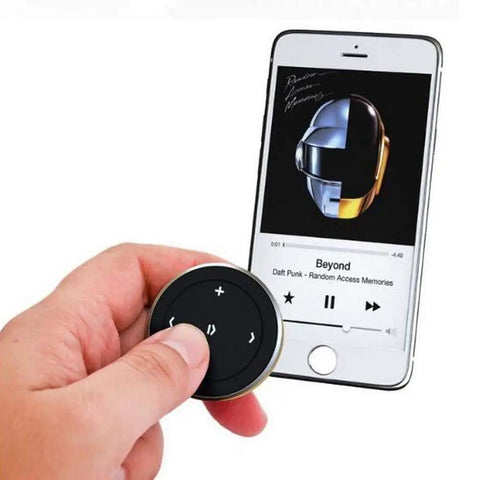 Wireless Bluetooth Car Media Button With Steering Wheel Remote next to smartphone displaying music app