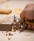 Premium Wood Carving Tools Kit Includes Hella Sharp Sloyd Knife carving wood with a chip blade, showing detail work in progress.