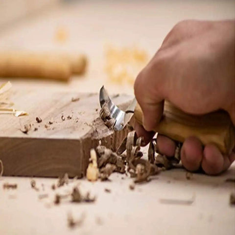 Premium Wood Carving Tools Kit Includes Hella Sharp Sloyd Knife carving wood with a chip blade, showing detail work in progress.